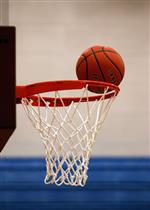 Basketball on rim of basket 